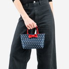 The Scarlet and Stars Petite Tote being held by a model