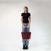 The Queen Of Hearts Medium Streamline Tote being used by a model