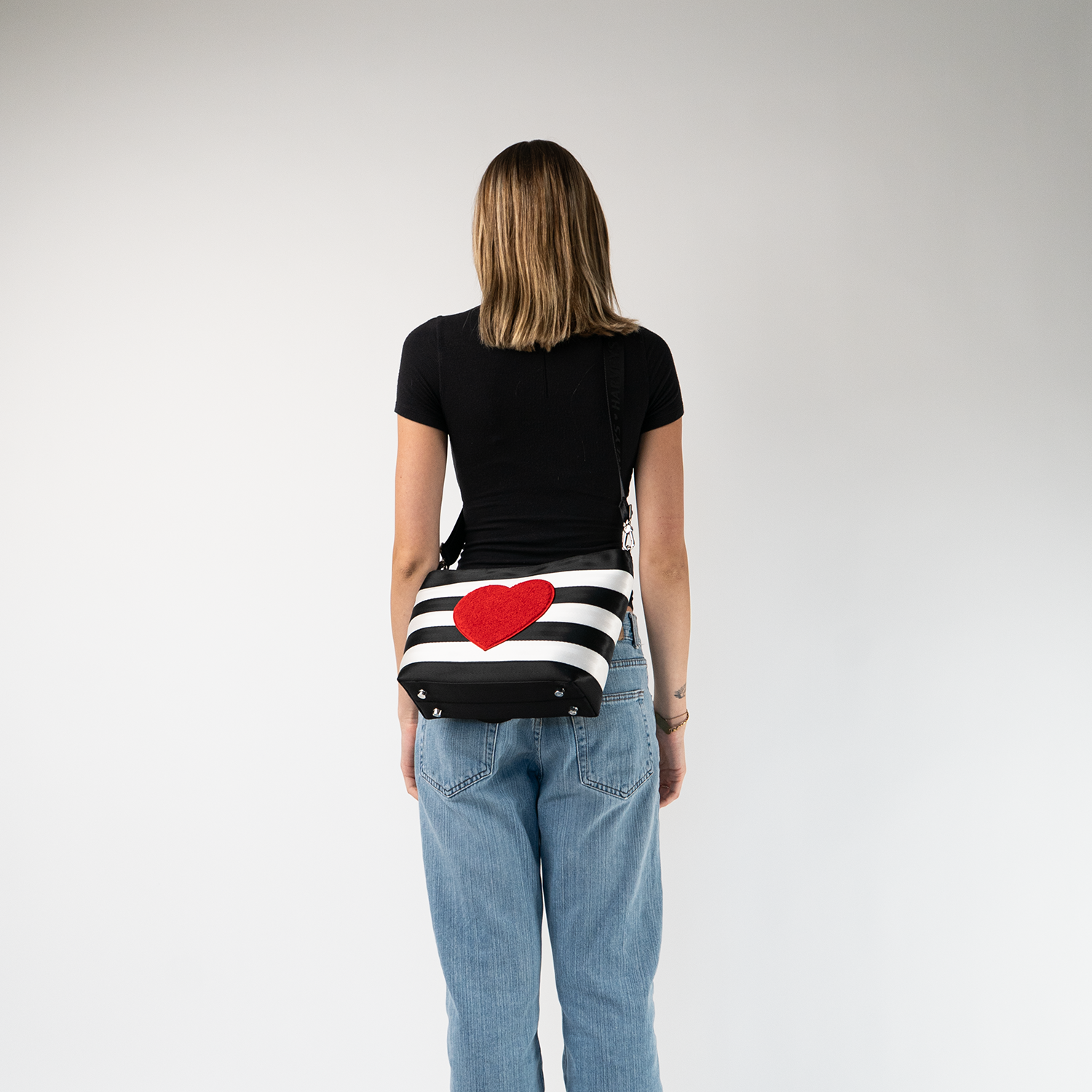 The Queen Of Hearts Mini Streamline Tote being worn by a model