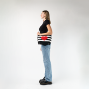 The Queen Of Hearts Mini Streamline Tote being worn by a model