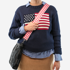 A red gingham 5 Panel Click N Carry being used by a model
