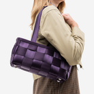 The Satchel in Blackberry being worn by a model