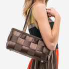 The Satchel in Espresso being worn by a model