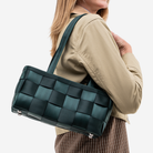 The Satchel in Nori being worn by a model