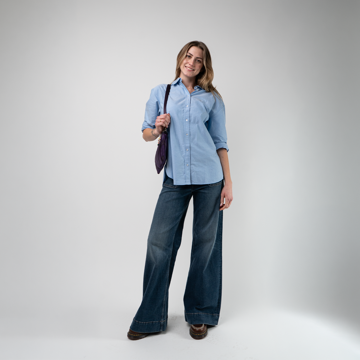 A Grape Soda Sydney Clutch being worn by a model