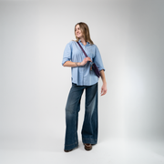 A Grape Soda Sydney Clutch being used by a model