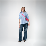 A Strawberry Lemonade Sydney Clutch being used by a model