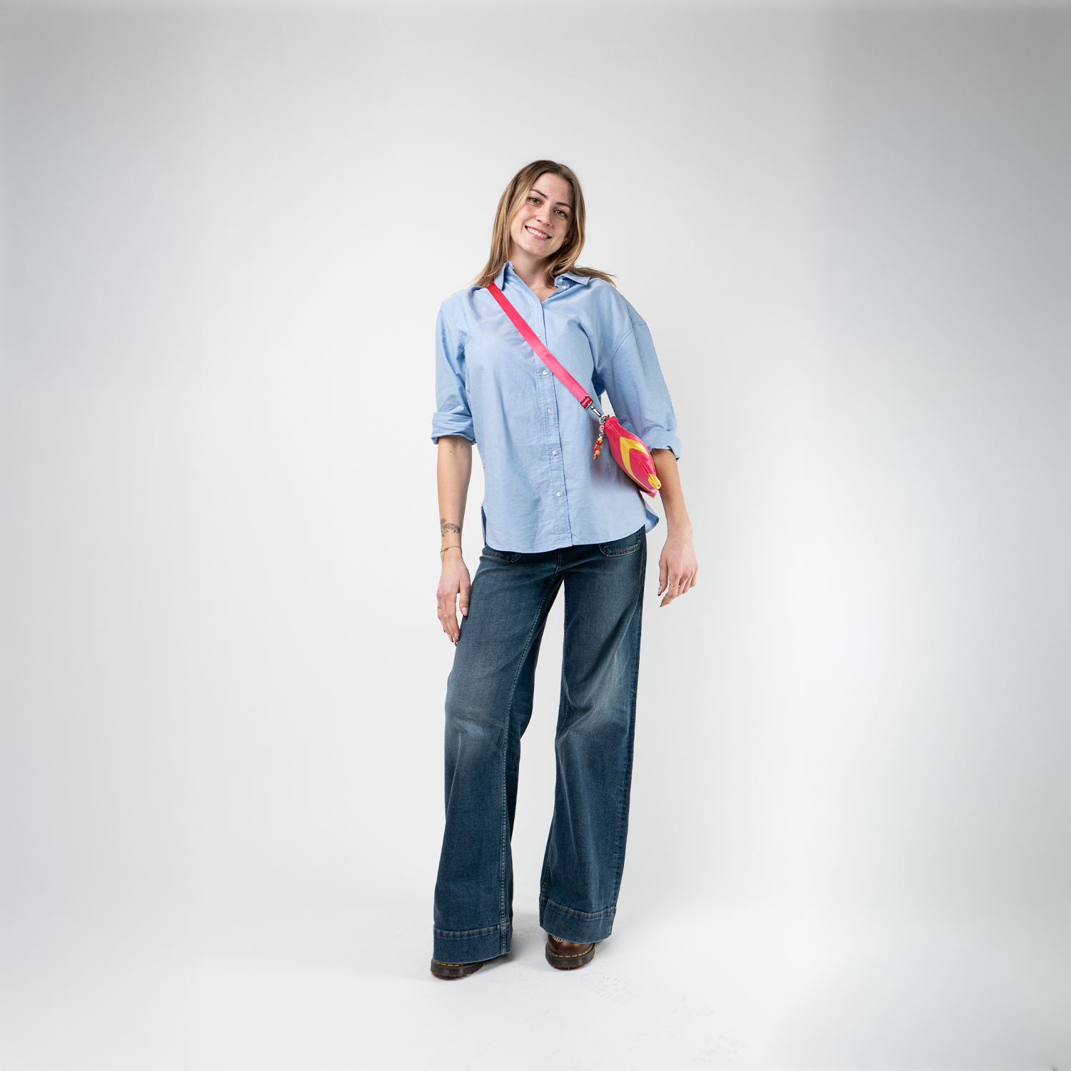 A Strawberry Lemonade Sydney Clutch being used by a model