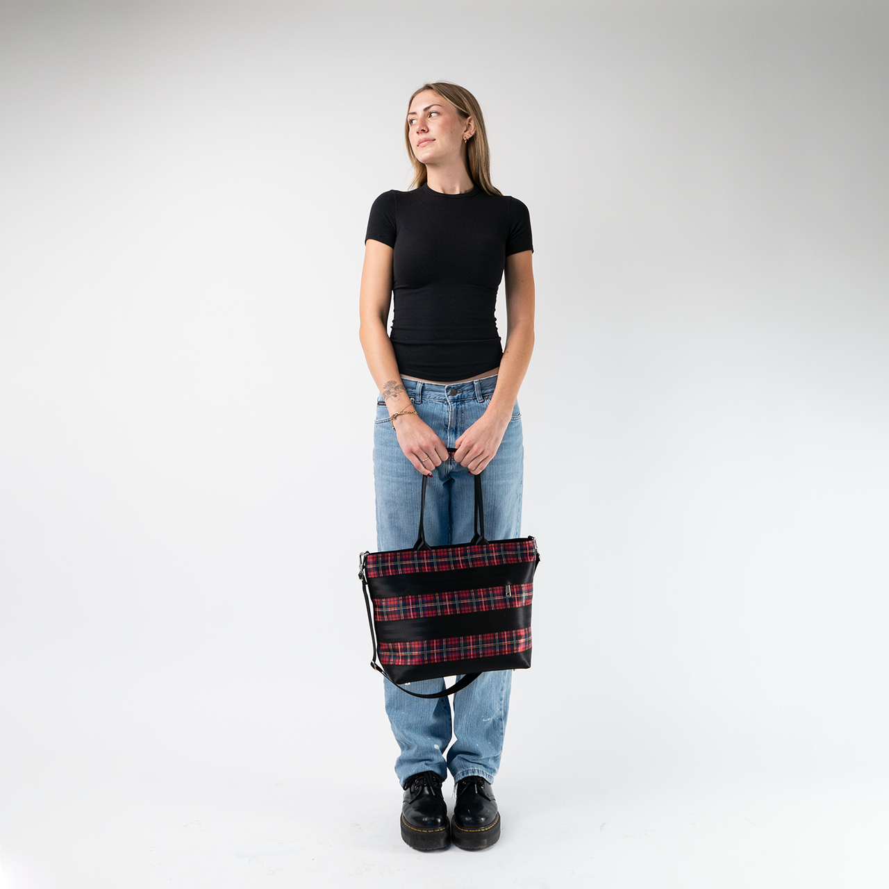 The Tartan Medium Streamline Tote being held by a model