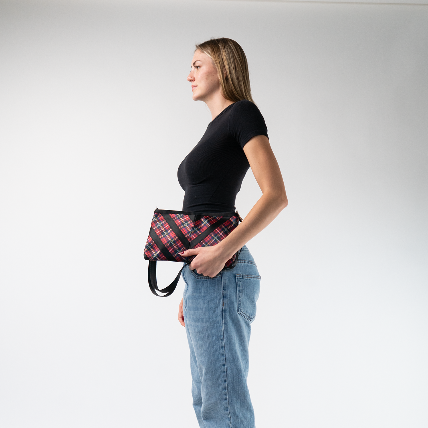 The Tartan Sydney Clutch in a models hands