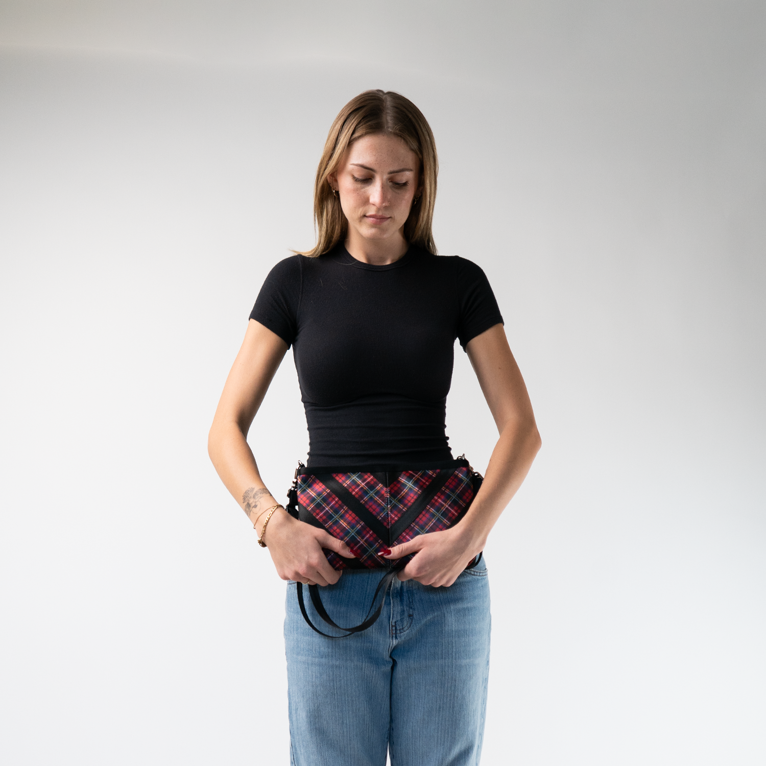 The Tartan Sydney Clutch in a models hands