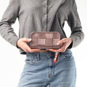 A Classic Wallet in Taupe being held in a Model's hands