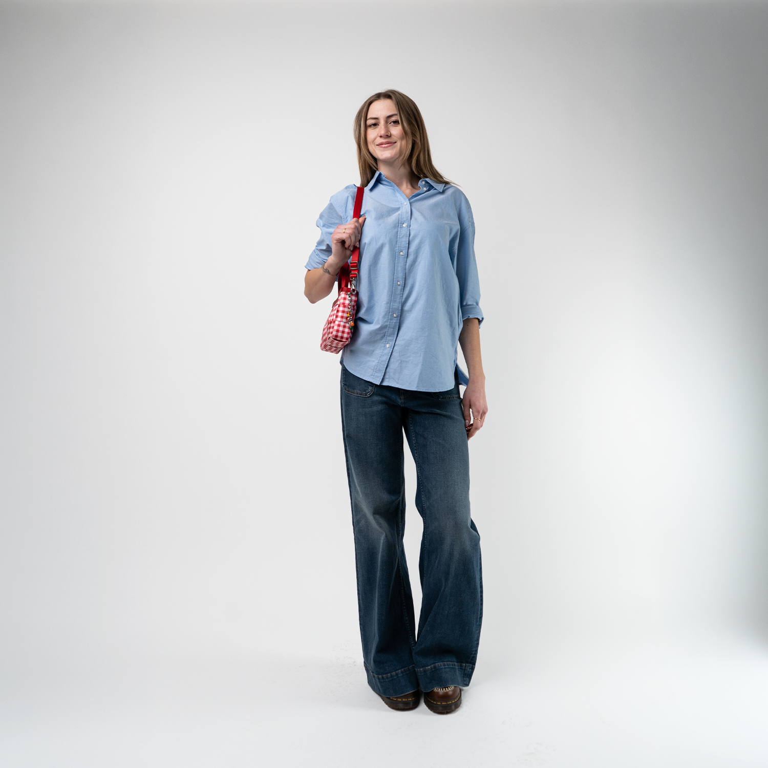 A Red Gingham Woven Petite Tote being used by a model